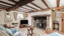 The sitting-room has a striking inglenook fireplace and a door that takes you out to the patio and glorious garden.