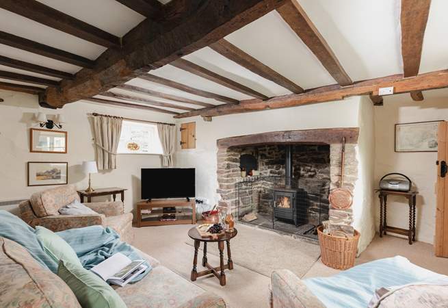The sitting-room has a fabulous inglenook fireplace and a door that takes you out to the patio and garden.