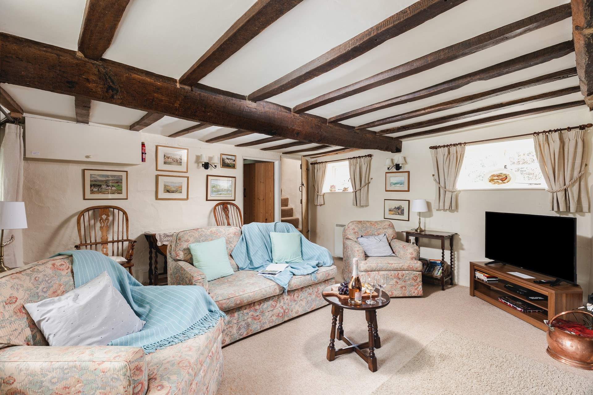 This period cottage has great character and plenty of traditional features. The door to the right leads to the stairs.