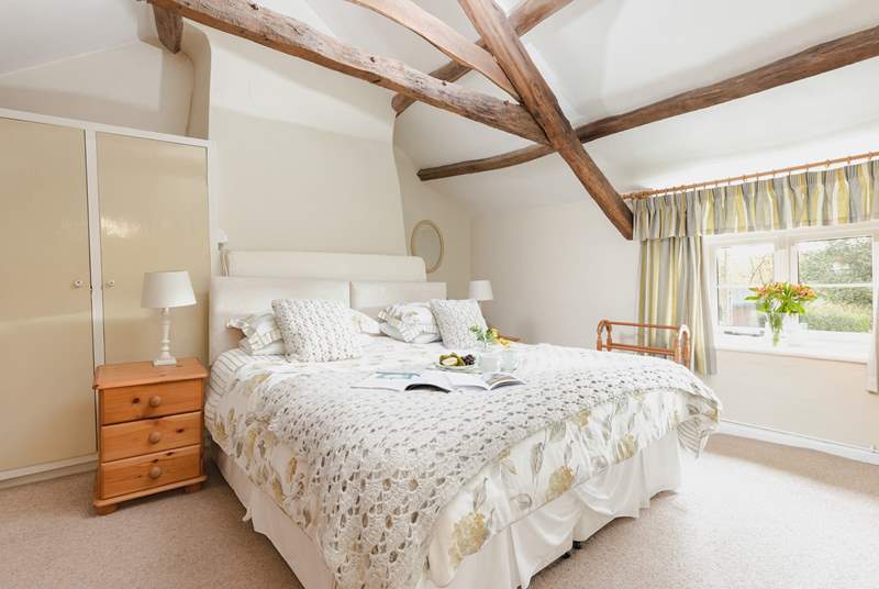 The main bedroom has a comfy super king bed and views into the garden.