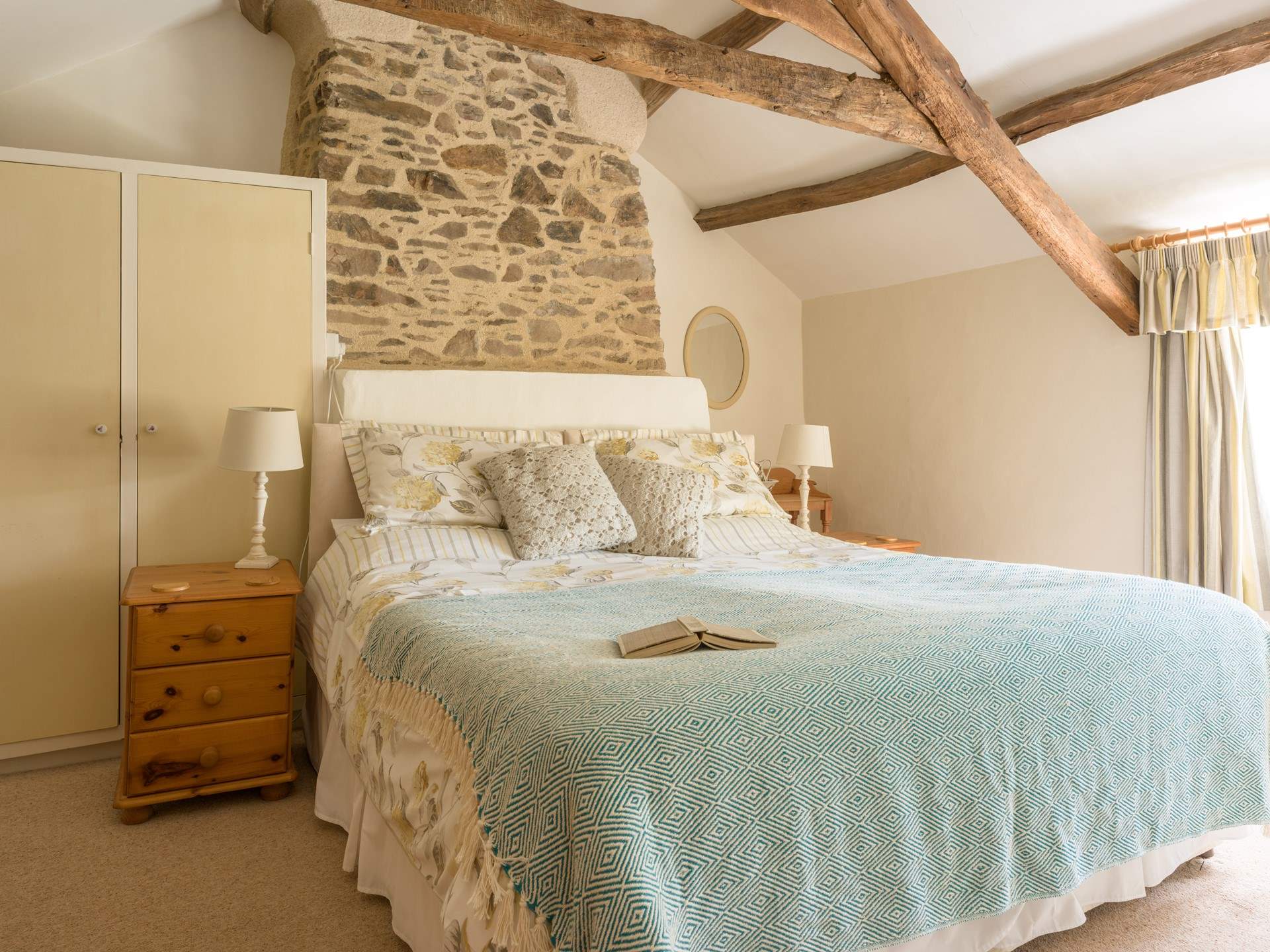The primary bedroom is quite special. A sumptuous king size bed, stunning views over the garden and packed with original charm and features.