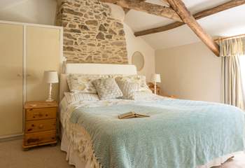 The primary bedroom is quite special. A sumptuous king size bed, stunning views over the garden and packed with original charm and features.