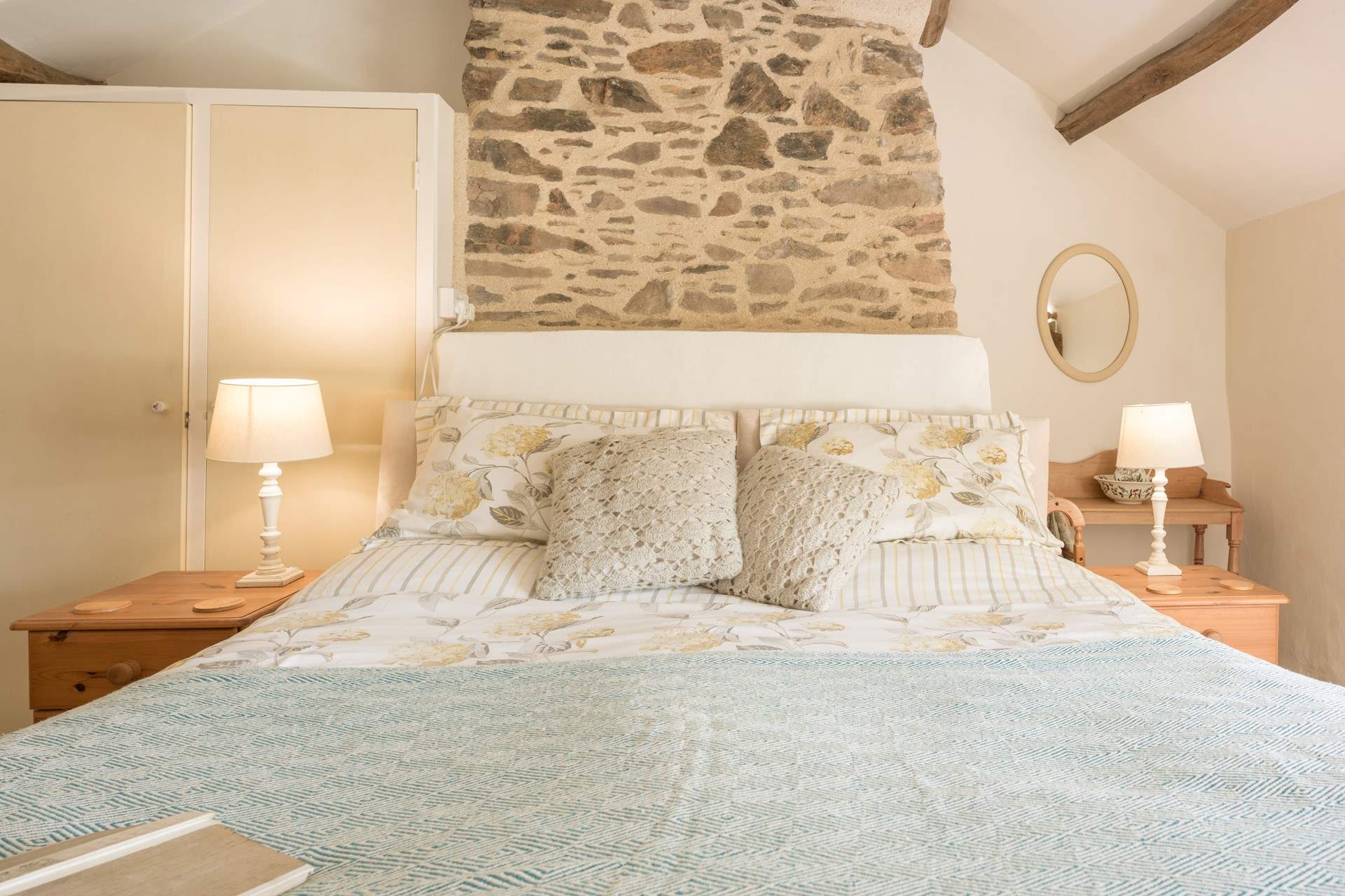 Paired back styling in the primary bedroom adds a touch of country-chic to your stay.