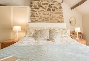 Paired back styling in the primary bedroom adds a touch of country-chic to your stay.