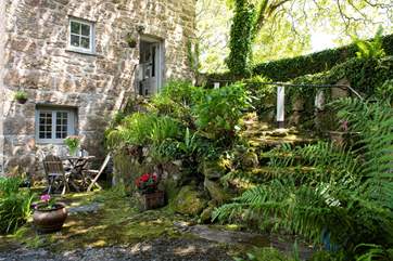 Steps lead up to the entrance of this gorgeous, converted water mill.