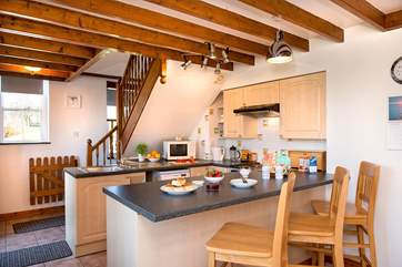 The breakfast bar separates the kitchen from the living-area.