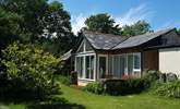 The timber-framed glass wall of the south-facing open plan living-room in Snuggledown, gives views over the fields and woods of Trevethey Farm. - Thumbnail Image