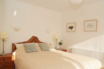The lovely bedroom shares the views over the lawn and fields.