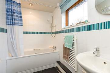 This is the bathroom, offering the option of both a bath and a shower.