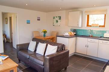The dining-table is at the back of the room but of course you can eat outside in the sunshine too.