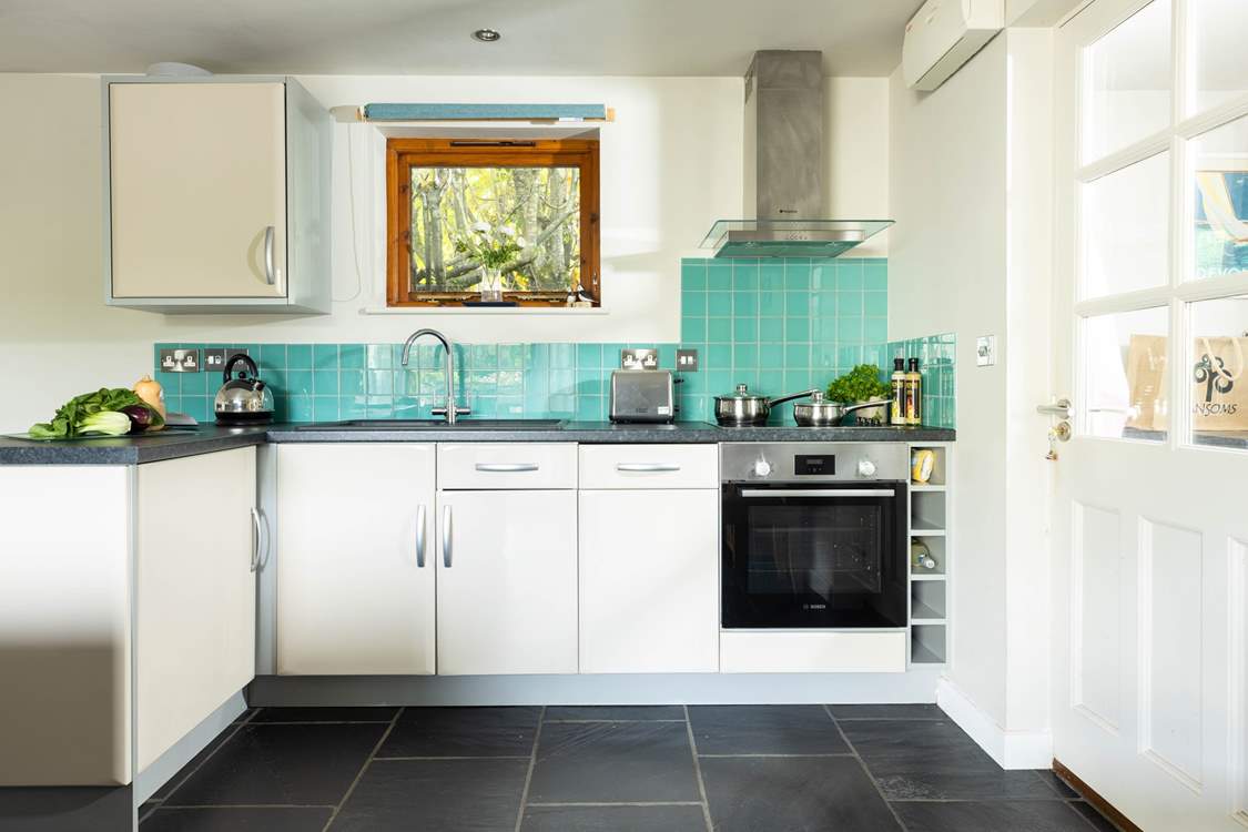 The utility-room and front door are to the right of the open plan living area!