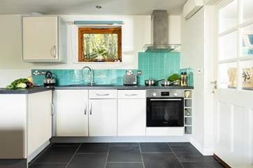 The utility room and front door are to the right of the open plan living area!