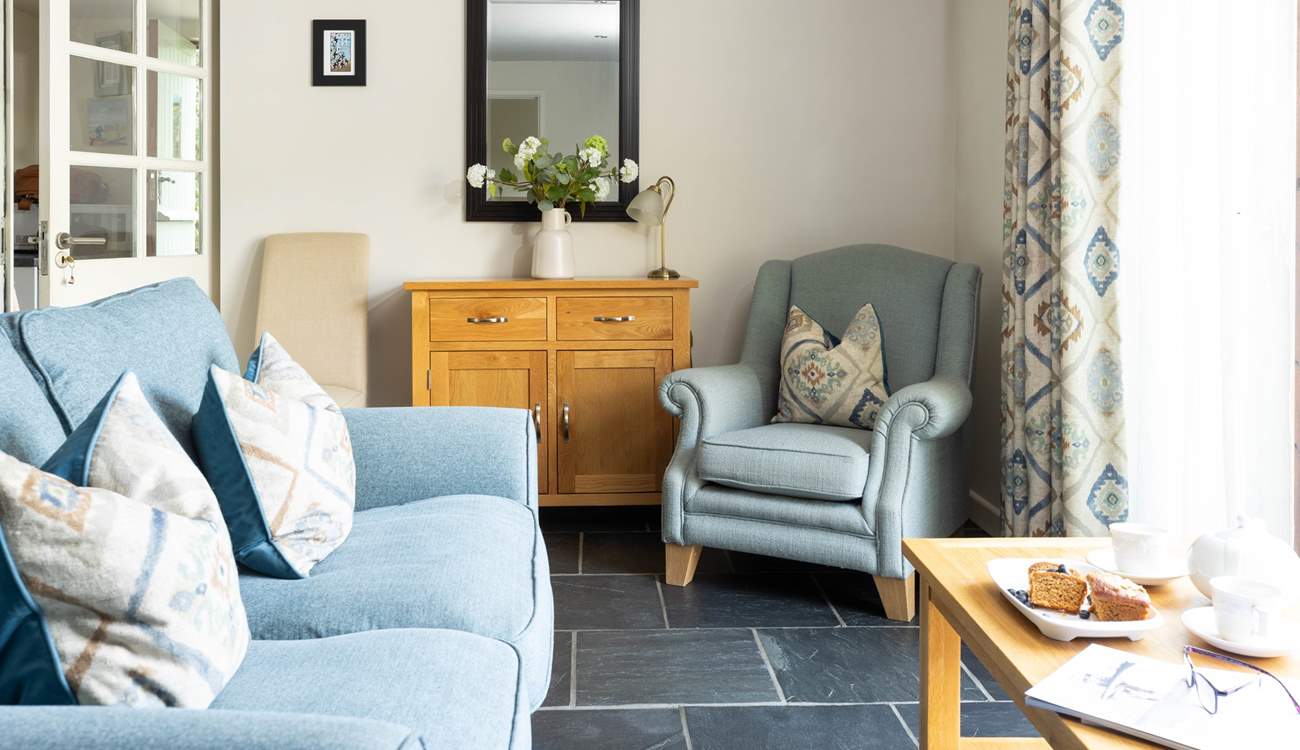 The sitting-area has French doors that open out onto a fully enclosed private patio at the side of the cottage.