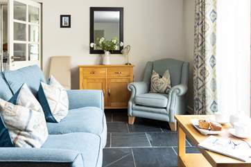 The sitting-area has French doors that open out onto a fully enclosed private patio at the side of the cottage.