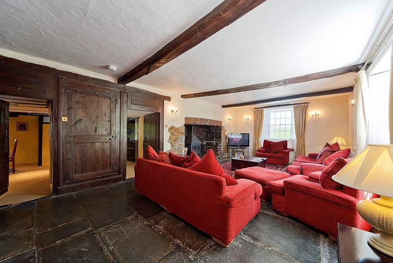 The very spacious sitting-room has a wood-burner and a huge television!
