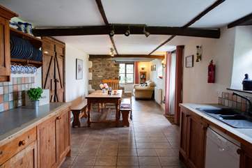 The sociable open plan kitchen and dining-areas lead through to the sitting-area.