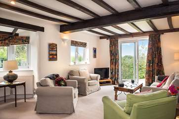 The large sitting-room enjoys views over the garden and undulating countryside.
