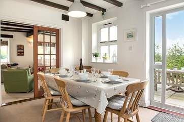 The dining-room sits between the kitchen and the sitting-room, with doors out to the dining terrace.