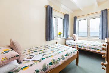 This delightful twin bedroom has captivating views.