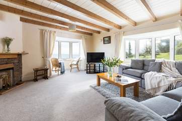 The cosy sitting-room has dual aspect windows for a panoramic view.