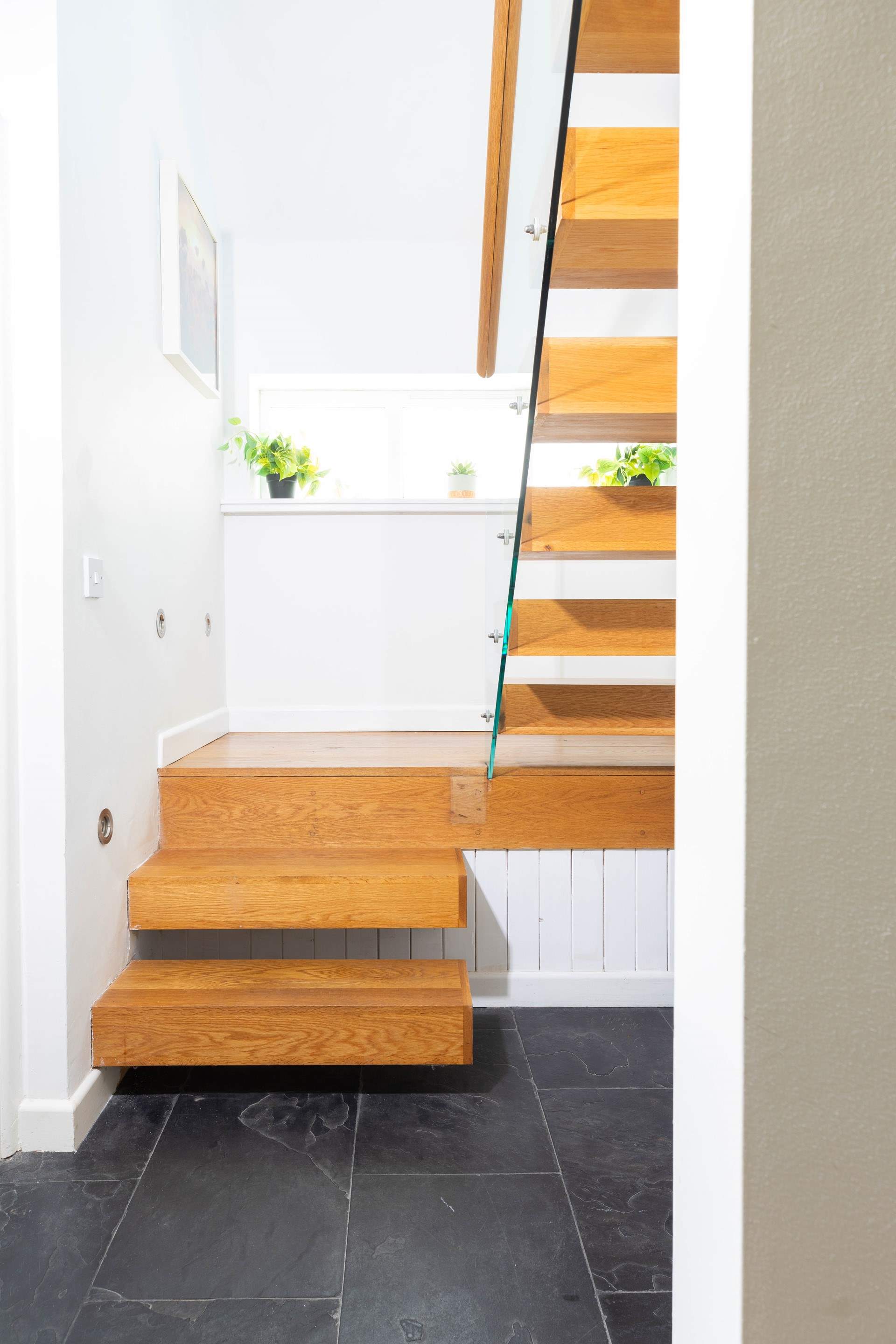 The modern stairs lead to the second sitting room and final bedroom.