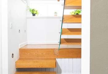 The modern stairs lead to the second sitting room and final bedroom.