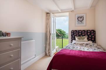 The single bedroom has a door out onto the garden.