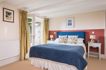 The gorgeous master bedroom has a comfy king-size bed.