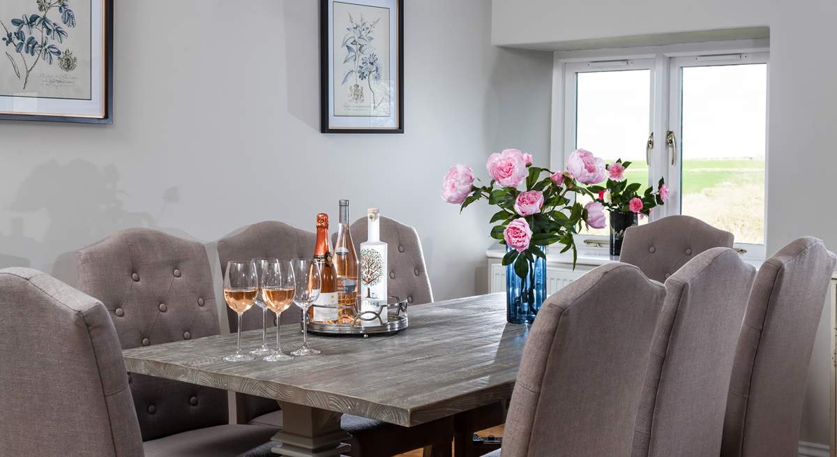 The gorgeous dining room overlooks the gardens and fields beyond. 