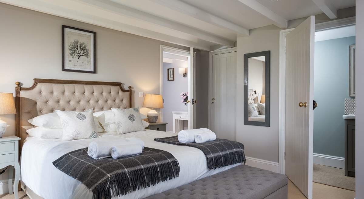 The beautiful main bedroom is an oasis of calm with a super comfy bed.