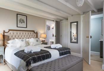 The beautiful main bedroom is an oasis of calm with a super comfy bed.