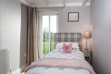 The single bedroom has a door out onto the garden.