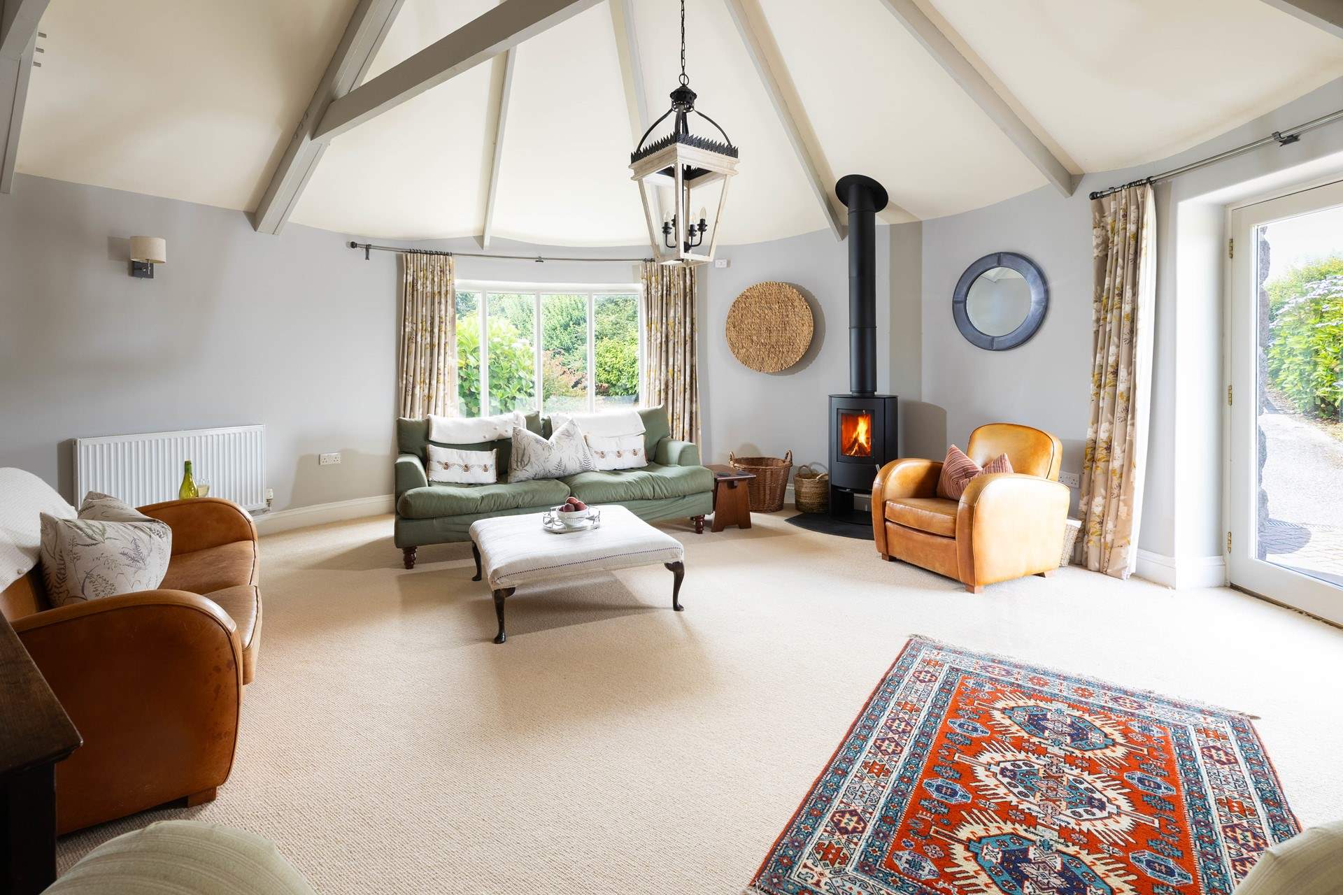 The light and airt sitting room can become super cosy with the curtains drawn and wood burner lit. 