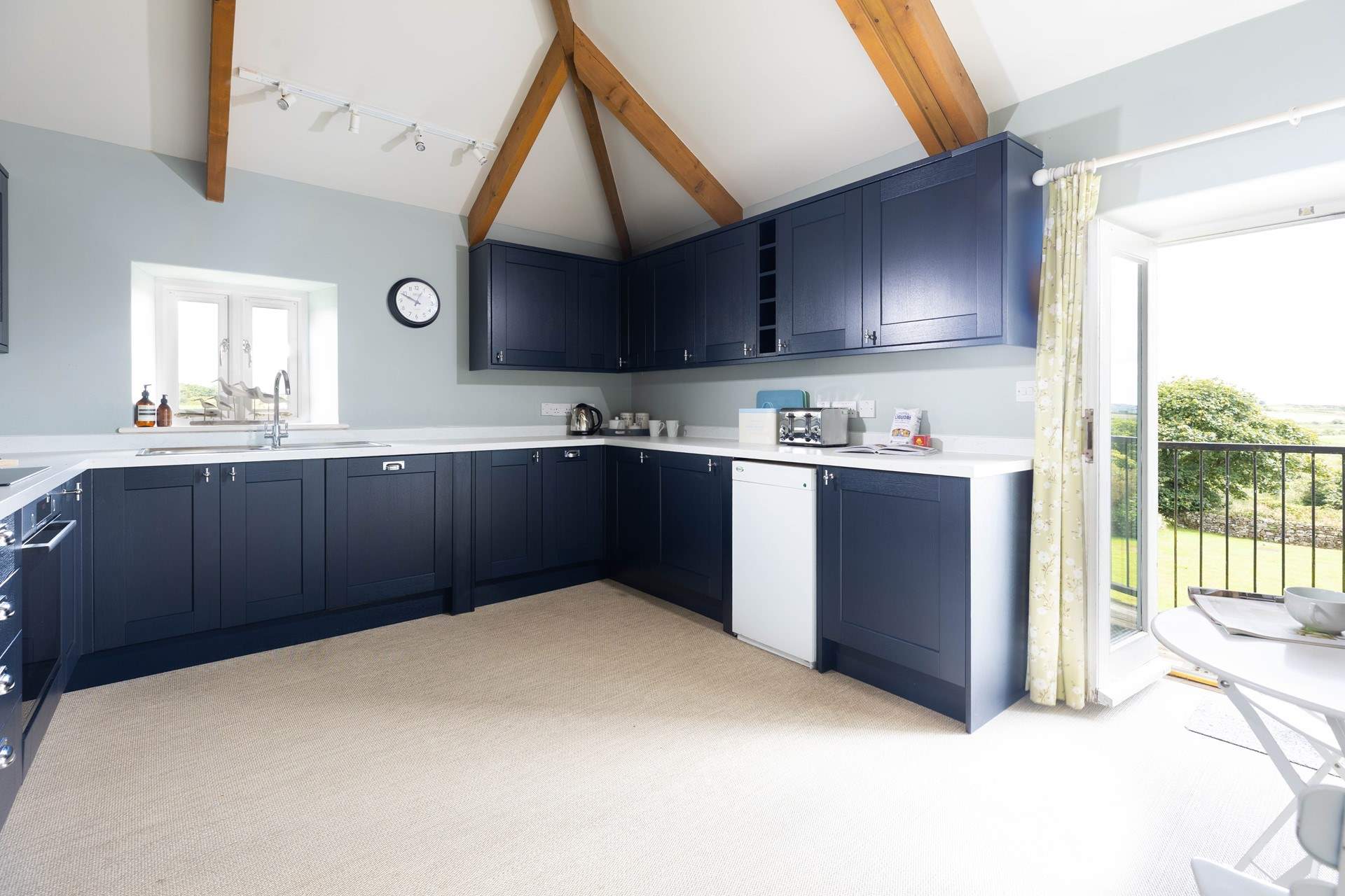 The large kitchen has the most amazing views over the countryside and doors that open to a small balcony and steps down to the garden. 