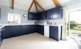 The large kitchen has the most amazing views over the countryside and doors that open to a small balcony and steps down to the garden.  - Thumbnail Image