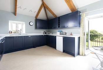 The large kitchen has the most amazing views over the countryside and doors that open to a small balcony and steps down to the garden. 