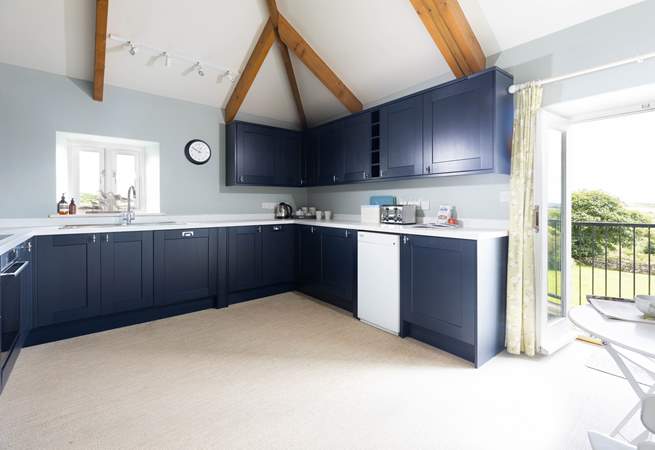 The large kitchen has the most amazing views over the countryside and doors that open to a small balcony and steps down to the garden. 