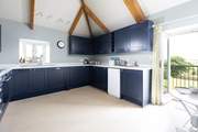The large kitchen has the most amazing views over the countryside and doors that open to a small balcony and steps down to the garden.