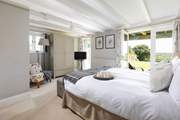 The principle bedroom has double doors that open to the large garden.