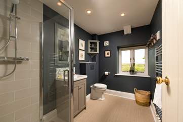 The stylish shower room is located between the living room and kitchen on the upper floor.