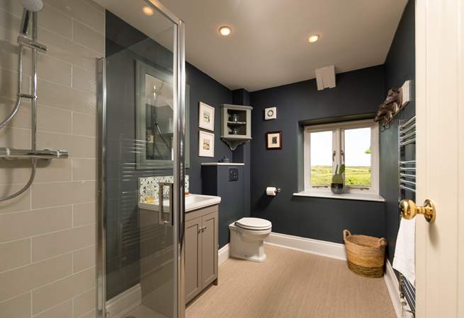 The stylish shower-room is located between the living room and kitchen on the upper floor.
