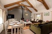 Room to relax and room to dine in this gorgeous living and dining space with a cosy wood-burner for those cooler days and nights.
