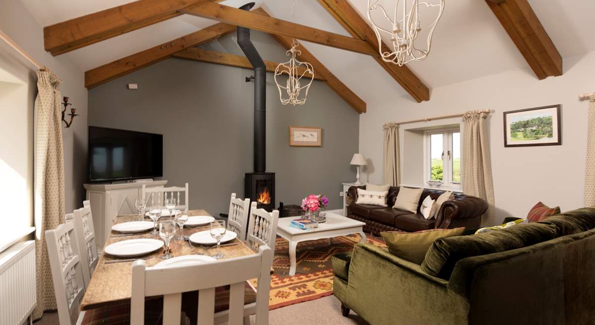 Room to relax and room to dine in this gorgeous living and dining space with a cosy wood-burner for those cooler days and nights.