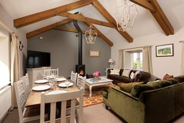 Room to relax and room to dine in this gorgeous living and dining space with a cosy wood burner for those cooler days and nights.