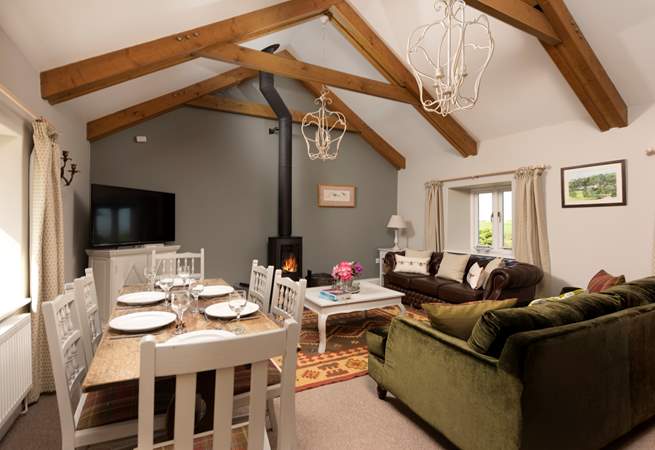 Room to relax and room to dine in this gorgeous living and dining space with a cosy wood-burner for those cooler days and nights.