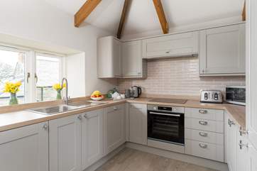 The well-equipped kitchen is on the first floor just along from the living-room so not far to go to get more ice for that G&T!