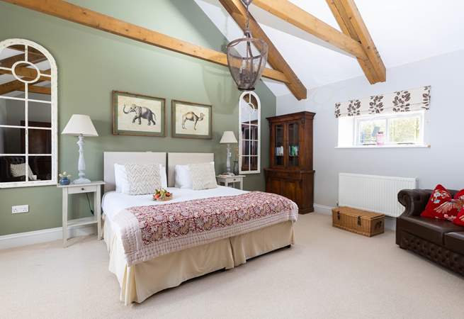 This bedroom has high vaulted ceilings to create a light and calming space. 