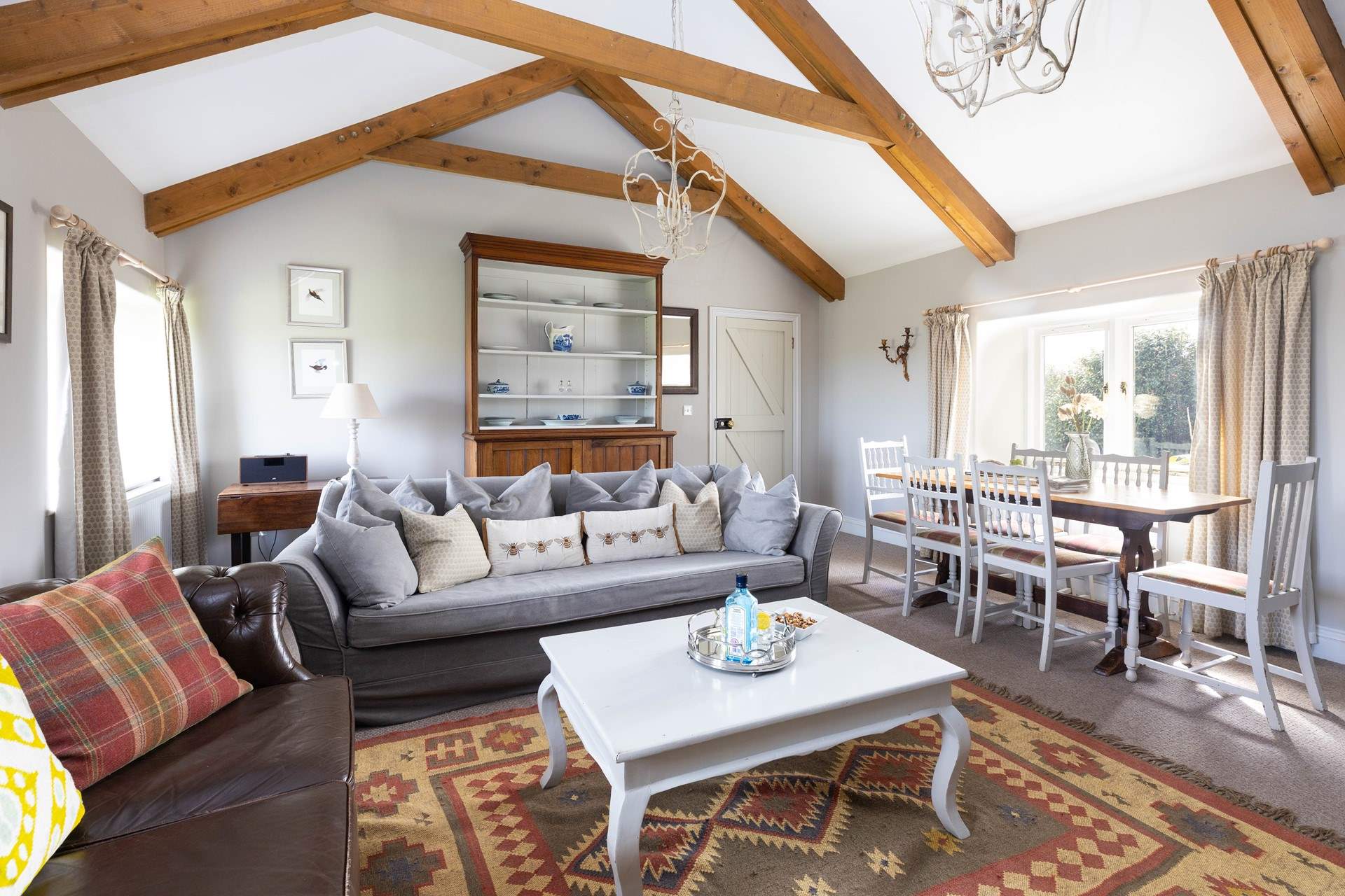 The light and airy sitting/ dining room with a cosy wood burner. 