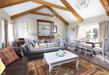 The light and airy sitting/ dining room with a cosy wood burner. 