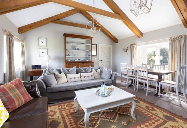 The light and airy sitting/ dining room with a cosy wood burner. 